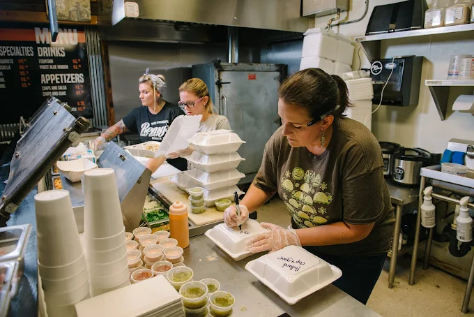 Remy's Chop Shop kitchen team plating takeout orders in Pryor OK